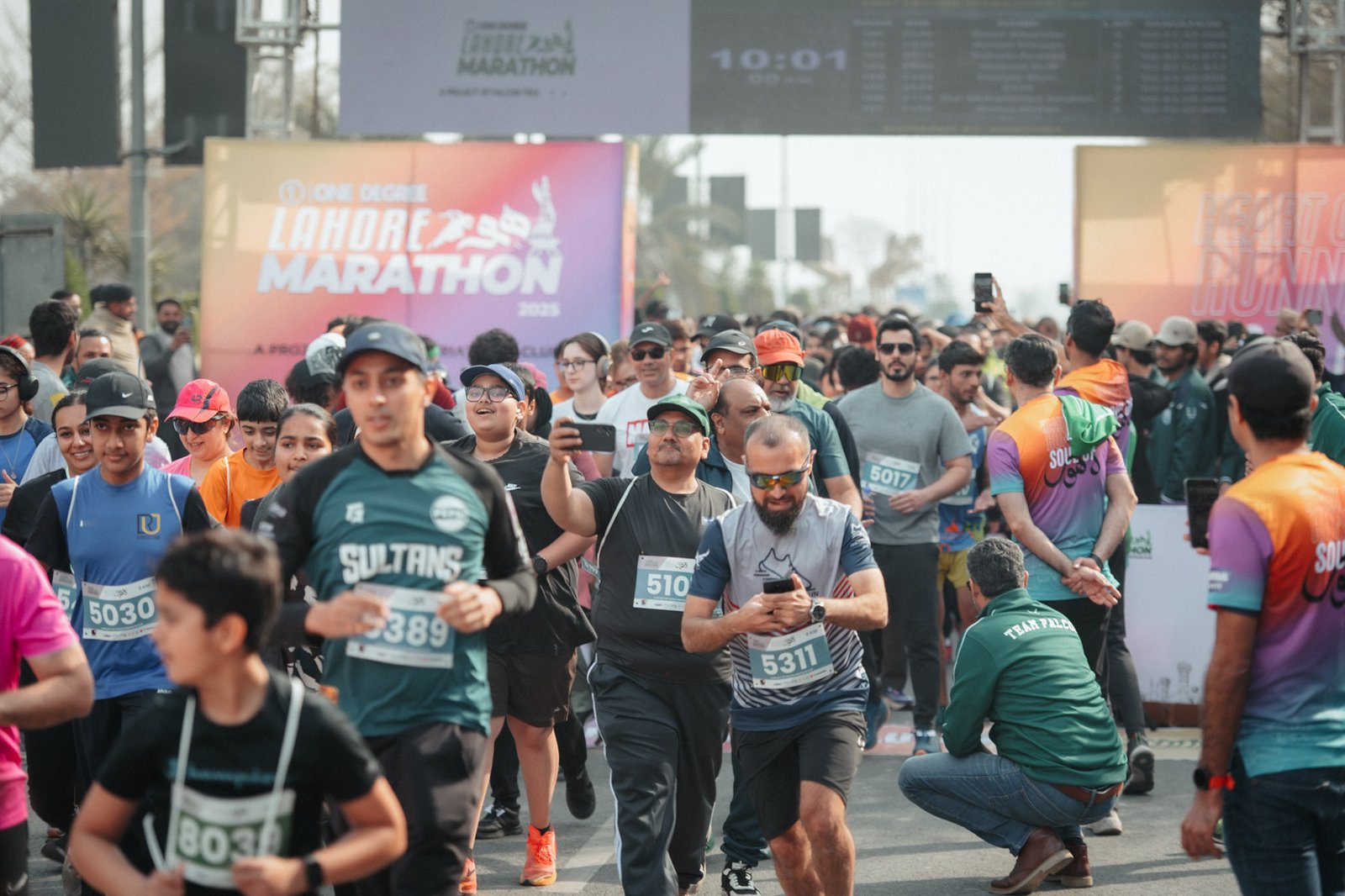 Runners massed under the Lahore Marathon start arch before the flag off